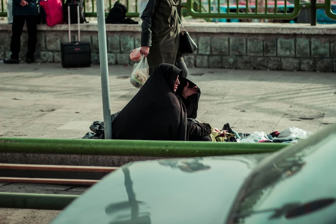 service dog school — Woman in black hijab sitting on the ground.